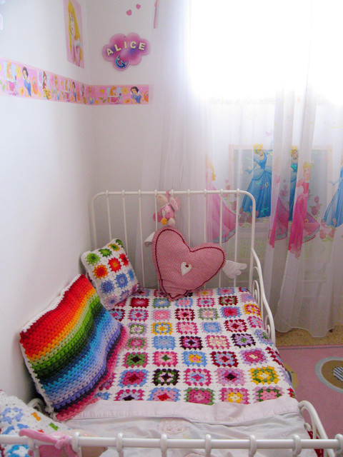 colourful crochet throw and rainbow cushion in baby's nursery